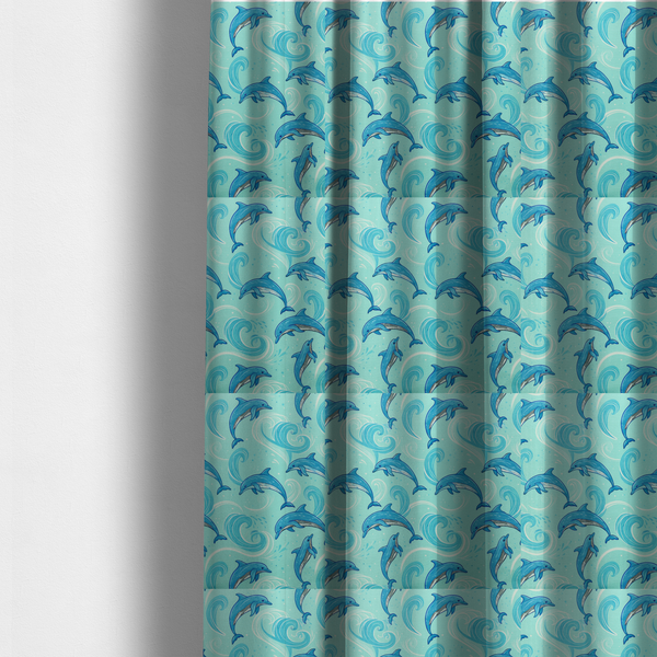 the fabric used to create these made-to-measure curtains is an aqua blue fabric with a repeating pattern of playful blue dolphins leaping through swirling white ocean waves and water splashes.   