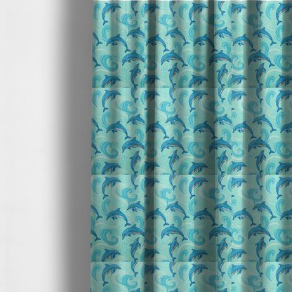 the fabric used to create these made-to-measure curtains is an aqua blue fabric with a repeating pattern of playful blue dolphins leaping through swirling white ocean waves and water splashes.   