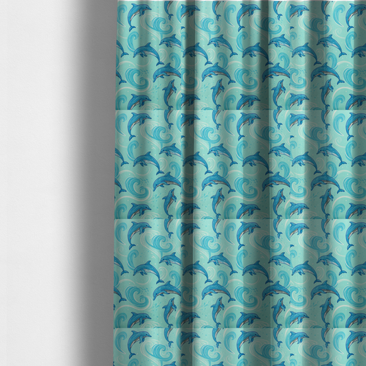 the fabric used to create these made-to-measure curtains is an aqua blue fabric with a repeating pattern of playful blue dolphins leaping through swirling white ocean waves and water splashes.   