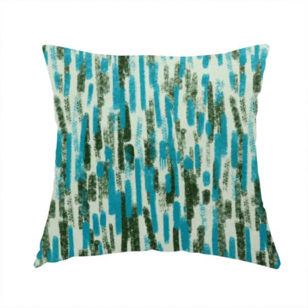 The fabric used to create this handmade cushion is a textured abstract pattern featuring vertical brushstrokes or chalk-like marks in shades of vibrant turquoise blue and deep forest green against a light off-white or cream background.