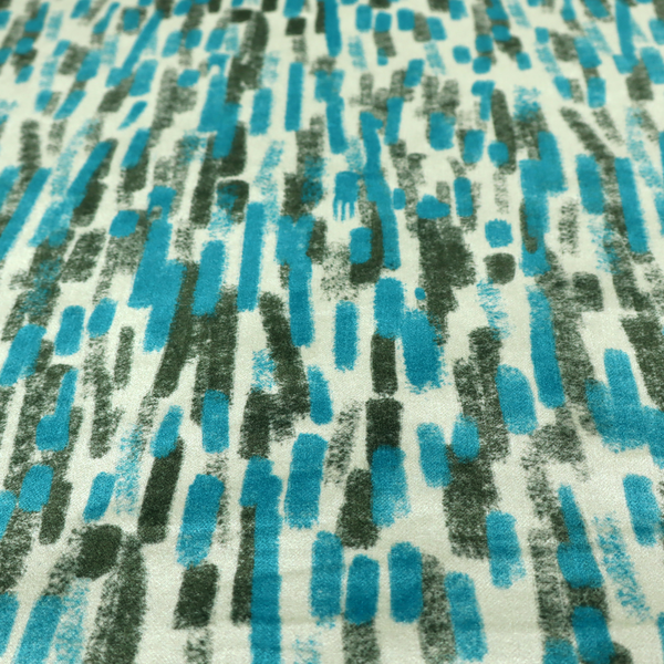 A textured abstract pattern featuring vertical brushstrokes or chalk-like marks in shades of vibrant turquoise blue and deep forest green against a light off-white or cream background.