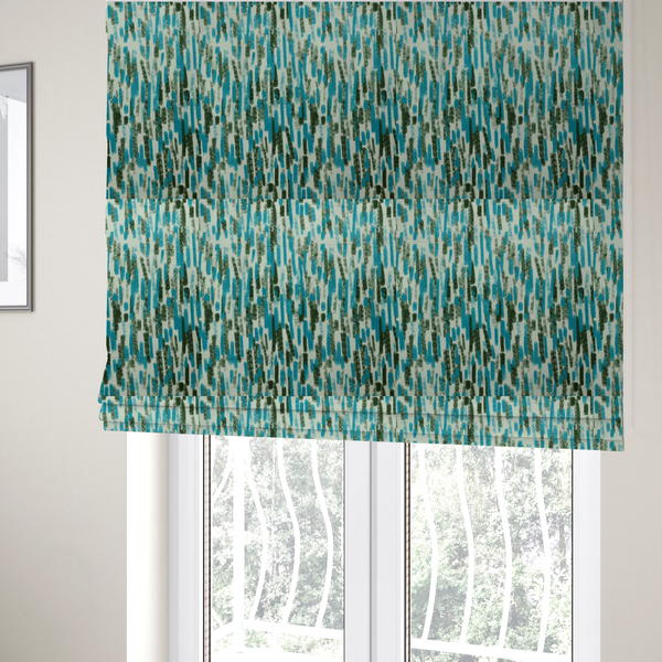 The fabric used to create these Roman blinds is a textured abstract pattern featuring vertical brushstrokes or chalk-like marks in shades of vibrant turquoise blue and deep forest green against a light off-white or cream background.