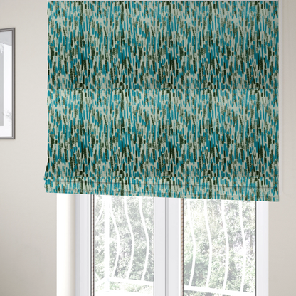The fabric used to create these Roman blinds is a textured abstract pattern featuring vertical brushstrokes or chalk-like marks in shades of vibrant turquoise blue and deep forest green against a light off-white or cream background.