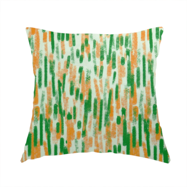 The fabric used to create this handmade cushion is a textured abstract pattern featuring vertical brushstrokes or chalk-like marks in shades of vibrant orange and green against a light off-white or cream background.   