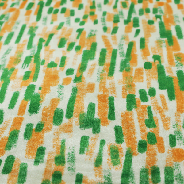 A textured abstract pattern featuring vertical brushstrokes or chalk-like marks in shades of vibrant orange and green against a light off-white or cream background.   