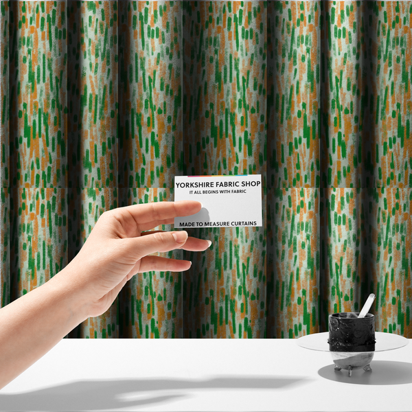 The fabric used to create these made-to-measure curtains is a textured abstract pattern featuring vertical brushstrokes or chalk-like marks in shades of vibrant orange and green against a light off-white or cream background.   