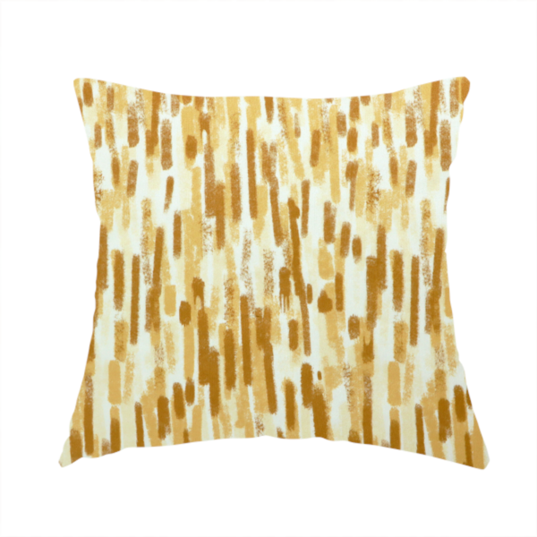 The fabric used to create this handmade cushion is a textured abstract pattern featuring vertical brushstrokes or chalk-like marks in shades of warm mustard yellow and golden brown against a light off-white or cream background.   