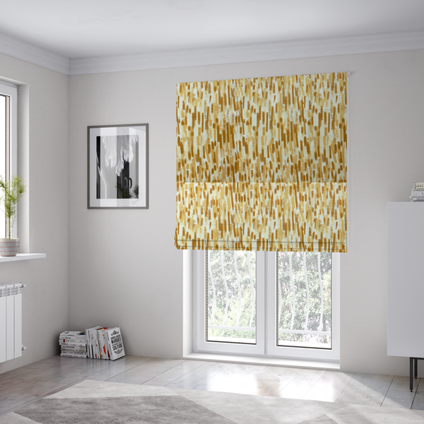 The fabric used to create these Roman blinds is a textured abstract pattern featuring vertical brushstrokes or chalk-like marks in shades of warm mustard yellow and golden brown against a light off-white or cream background.   