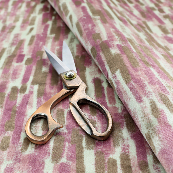 A textured abstract pattern featuring vertical brushstrokes or chalk-like marks in shades of dusty pink and bronze-brown against a light off-white or cream background.   