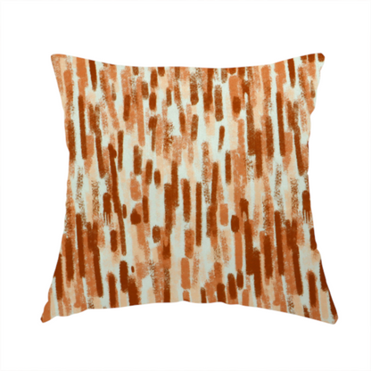 The fabric used to create this handmade cushion is a textured abstract pattern featuring vertical brushstrokes or chalk-like marks in shades of warm terracotta and burnt orange against a light off-white or cream background.