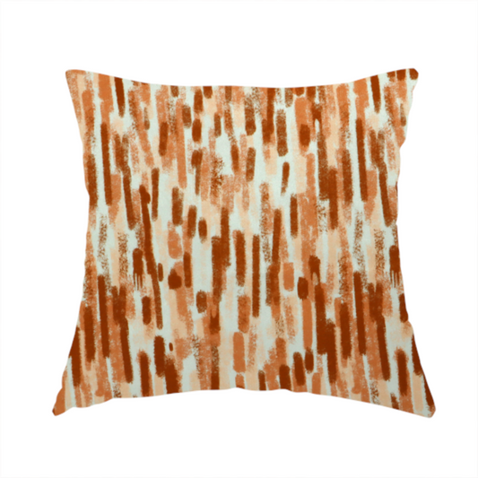 The fabric used to create this handmade cushion is a textured abstract pattern featuring vertical brushstrokes or chalk-like marks in shades of warm terracotta and burnt orange against a light off-white or cream background.