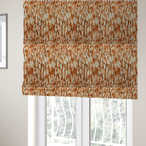The fabric used to create these Roman blinds is a textured abstract pattern featuring vertical brushstrokes or chalk-like marks in shades of warm terracotta and burnt orange against a light off-white or cream background.