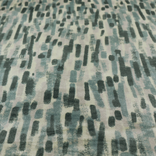 Fabric featuring an abstract vertical brushstroke pattern in dark green, sage, and grey on a light neutral background.   