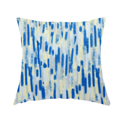 The fabric used to create this handmade cushion is a fabric featuring an abstract, vertical brushstroke pattern in vibrant cobalt blue, soft pastel yellow, and light grey.