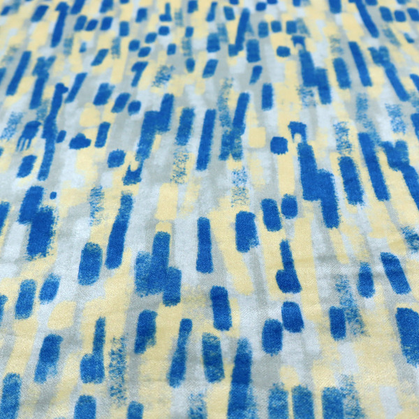 Fabric featuring an abstract, vertical brushstroke pattern in vibrant cobalt blue, soft pastel yellow, and light grey.