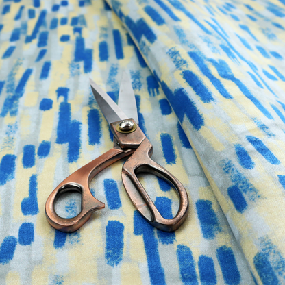 Fabric featuring an abstract, vertical brushstroke pattern in vibrant cobalt blue, soft pastel yellow, and light grey.
