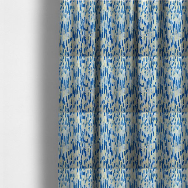 The fabric used to create these made-to-measure curtains is a fabric featuring an abstract, vertical brushstroke pattern in vibrant cobalt blue, soft pastel yellow, and light grey.
