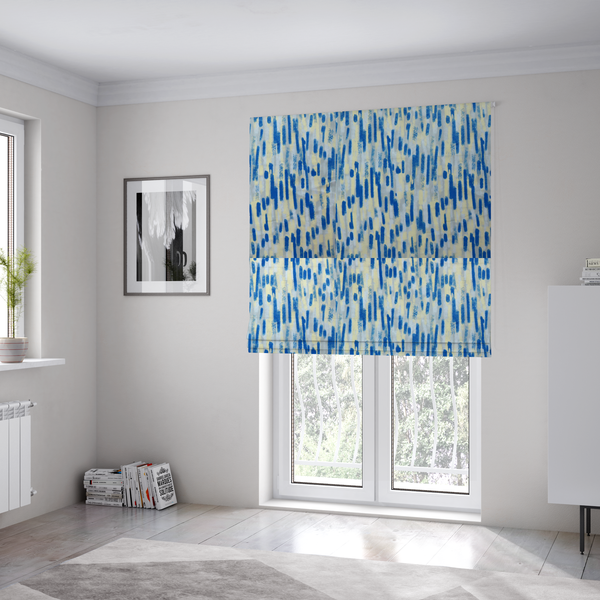 The fabric used to create these Roman blinds is a fabric featuring an abstract, vertical brushstroke pattern in vibrant cobalt blue, soft pastel yellow, and light grey.