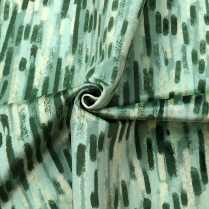Fabric featuring an abstract vertical brushstroke pattern in dark green, mint, and sage on a soft seafoam background.