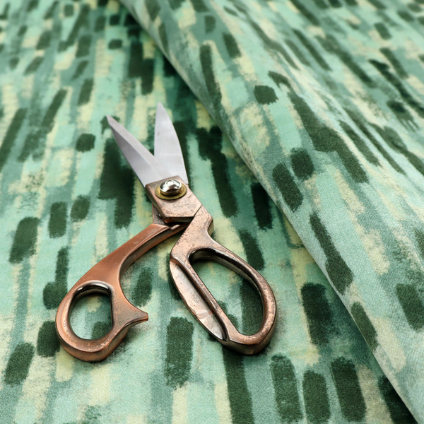 Fabric featuring an abstract vertical brushstroke pattern in dark green, mint, and sage on a soft seafoam background.