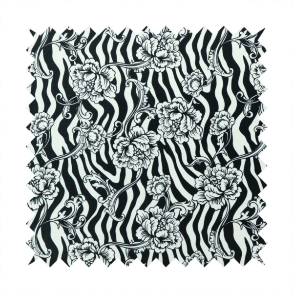 Black and white fabric featuring an ornate floral peony trail layered over a wavy zebra stripe background.   