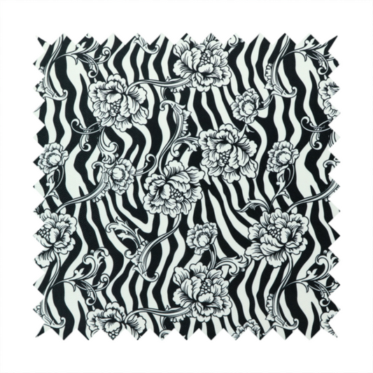 Black and white fabric featuring an ornate floral peony trail layered over a wavy zebra stripe background.   