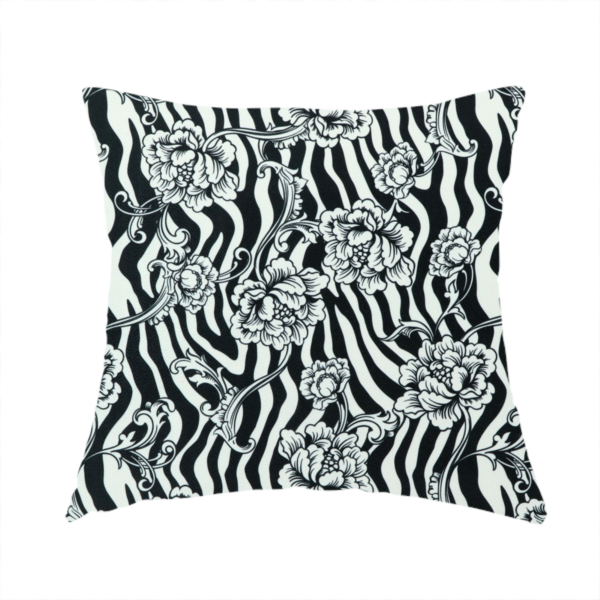 The fabric used to create this handmade cushion is a black and white fabric featuring an ornate floral peony trail layered over a wavy zebra stripe background.   