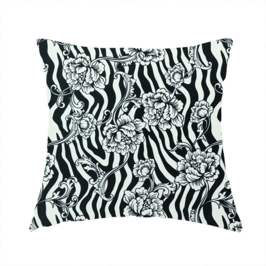 The fabric used to create this handmade cushion is a black and white fabric featuring an ornate floral peony trail layered over a wavy zebra stripe background.   