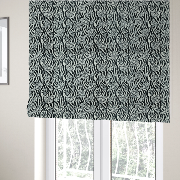 The fabric used to create these Roman blinds is a black and white fabric featuring an ornate floral peony trail layered over a wavy zebra stripe background.   