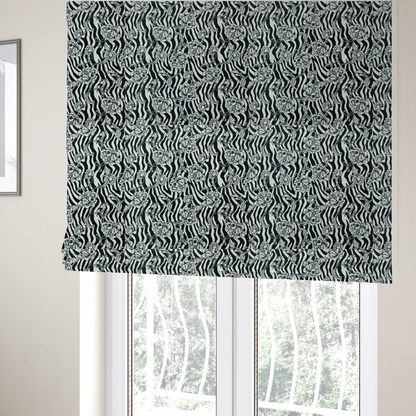 The fabric used to create these Roman blinds is a black and white fabric featuring an ornate floral peony trail layered over a wavy zebra stripe background.   