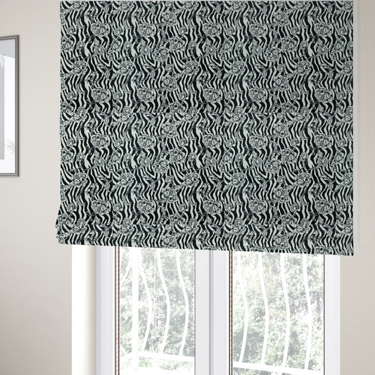The fabric used to create these Roman blinds is a black and white fabric featuring an ornate floral peony trail layered over a wavy zebra stripe background.   