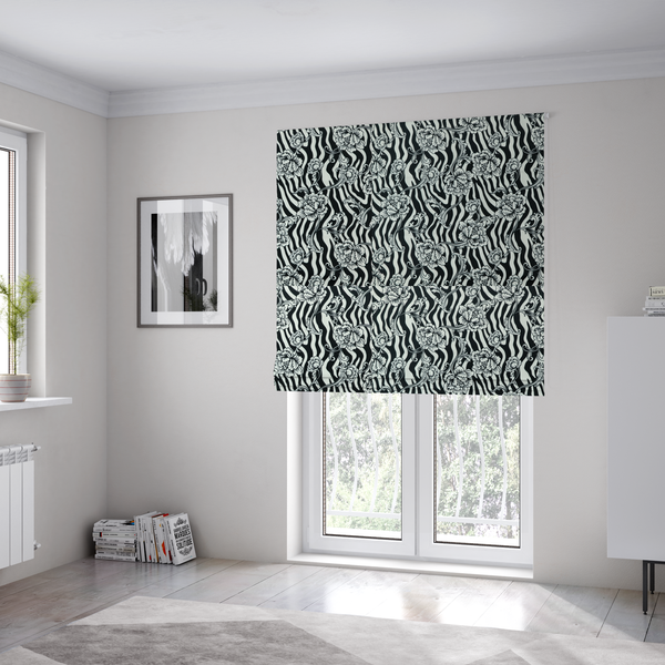 The fabric used to create these Roman blinds is a black and white fabric featuring an ornate floral peony trail layered over a wavy zebra stripe background.   