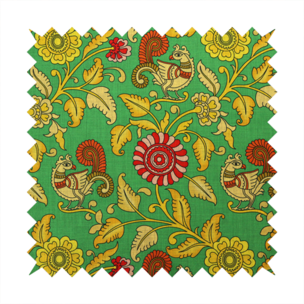 Indian Kalamkari fabric pattern featuring stylized peacocks, golden floral vines, and red rosettes on a vibrant emerald green background.   