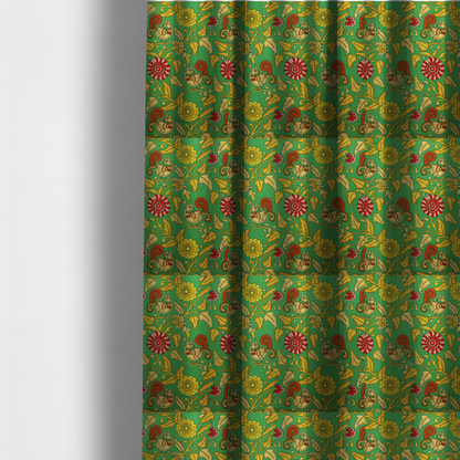 The fabric used to create these made-to-measure curtains is an Indian Kalamkari fabric pattern featuring stylized peacocks, golden floral vines, and red rosettes on a vibrant emerald green background.   