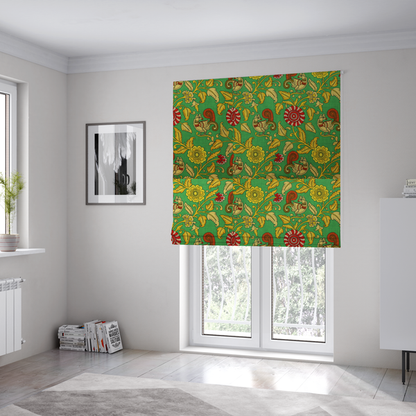 The fabric used to create these Roman blinds is an Indian Kalamkari fabric pattern featuring stylized peacocks, golden floral vines, and red rosettes on a vibrant emerald green background.   
