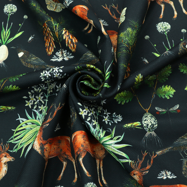 Symmetrical woodland fabric pattern featuring reddish-brown stags with antlers, pinecones, birds, nests with eggs, and botanical flora on a black background.   