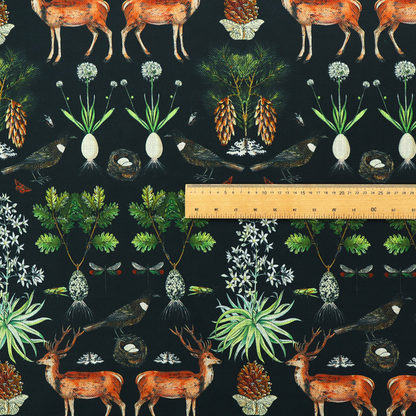 Symmetrical woodland fabric pattern featuring reddish-brown stags with antlers, pinecones, birds, nests with eggs, and botanical flora on a black background.   