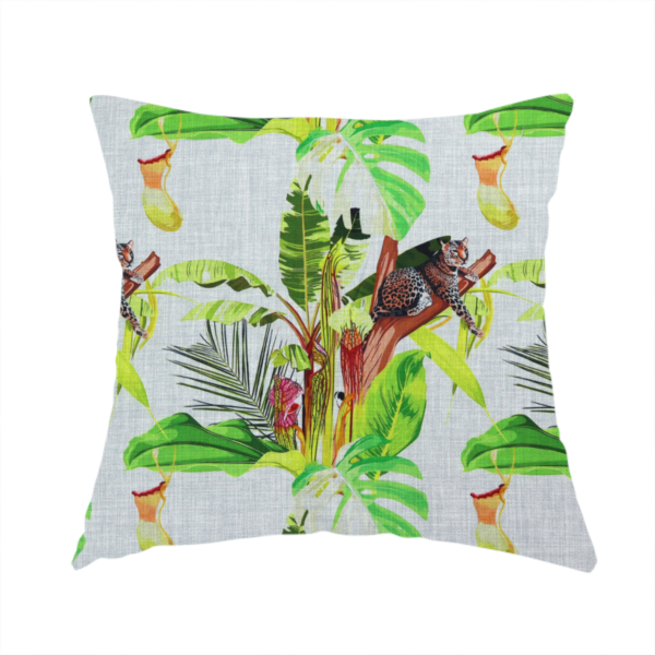 The fabric used to create this handmade cushion is a tropical jungle fabric featuring leopards resting on tree branches alongside pitcher plants, banana leaves, and Monstera foliage on a light grey textured background.