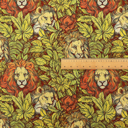 Fabric pattern featuring male lions emerging from dense, golden-yellow foliage and red flowers in an illustrated Arts and Crafts style.   