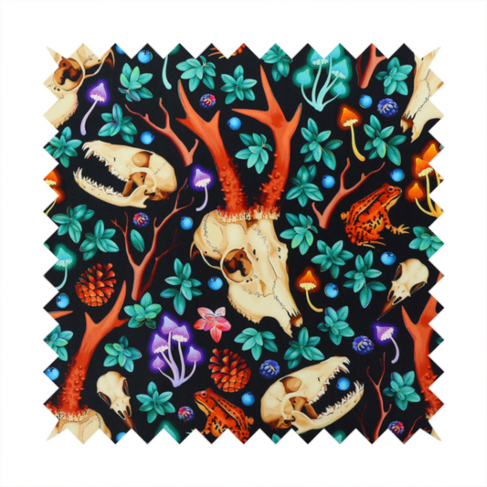 Gothic forest fabric featuring animal skulls with red antlers, bright orange toads, colourful mushrooms, berries, and green foliage on a black background.   