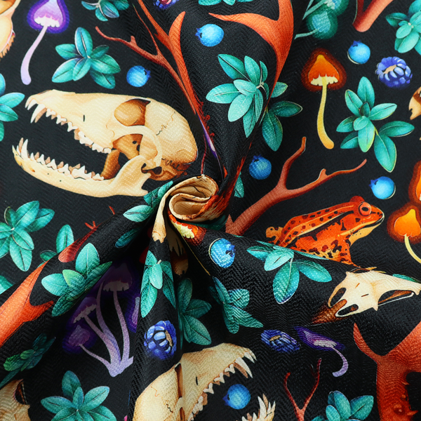 Gothic forest fabric featuring animal skulls with red antlers, bright orange toads, colourful mushrooms, berries, and green foliage on a black background.   