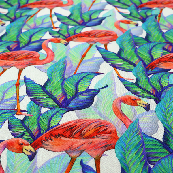 Vibrant tropical fabric pattern featuring coral-pink flamingos nestled among lush green, teal, and blue palm foliage against a white background.   