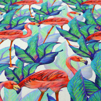 Vibrant tropical fabric pattern featuring coral-pink flamingos nestled among lush green, teal, and blue palm foliage against a white background.   