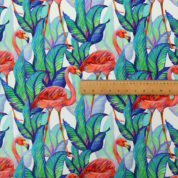 Vibrant tropical fabric pattern featuring coral-pink flamingos nestled among lush green, teal, and blue palm foliage against a white background.   