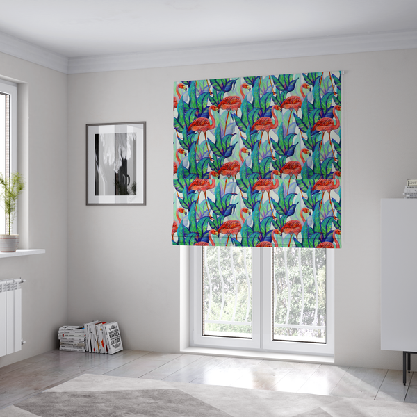 The fabric used to create these Roman blinds is a vibrant tropical fabric pattern featuring coral-pink flamingos nestled among lush green, teal, and blue palm foliage against a white background.   