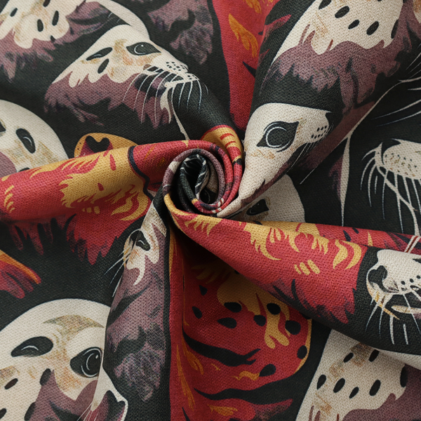 Fabric print featuring a repeating pattern of seals and sea lions in shades of cream, ochre yellow, and coral red on a dark charcoal background.   