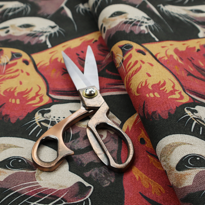 Fabric print featuring a repeating pattern of seals and sea lions in shades of cream, ochre yellow, and coral red on a dark charcoal background.   