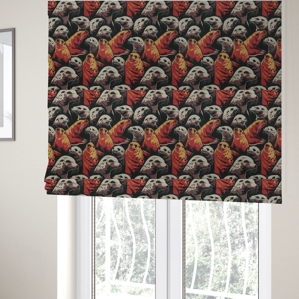 The fabric used to create these Roman blinds is a fabric print featuring a repeating pattern of seals and sea lions in shades of cream, ochre yellow, and coral red on a dark charcoal background.   