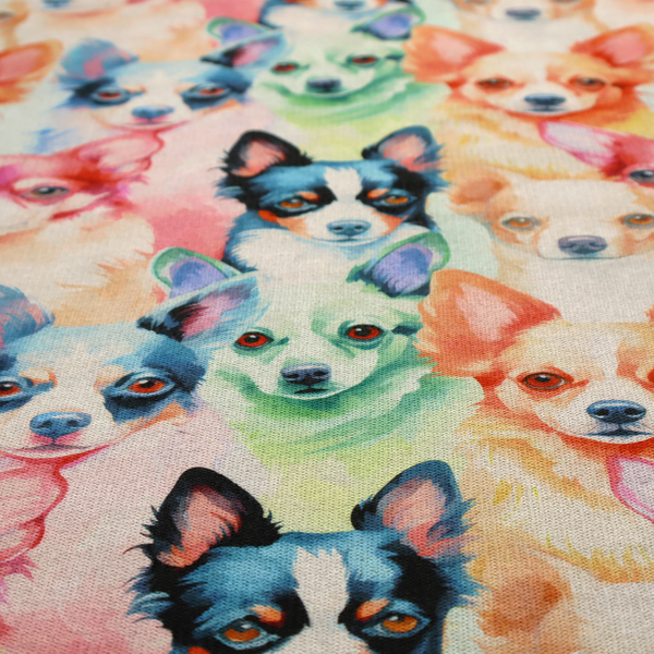 Colourful fabric pattern featuring watercolour portraits of chihuahuas in shades of tan, pink, blue, green, and black on a light cream background.   
