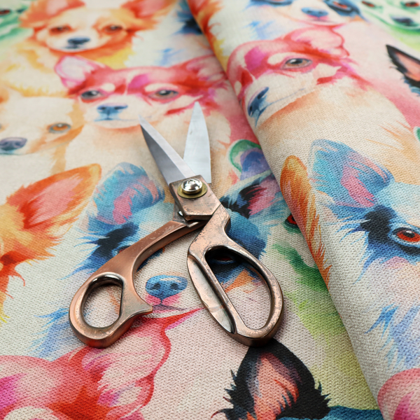 Colourful fabric pattern featuring watercolour portraits of chihuahuas in shades of tan, pink, blue, green, and black on a light cream background.   